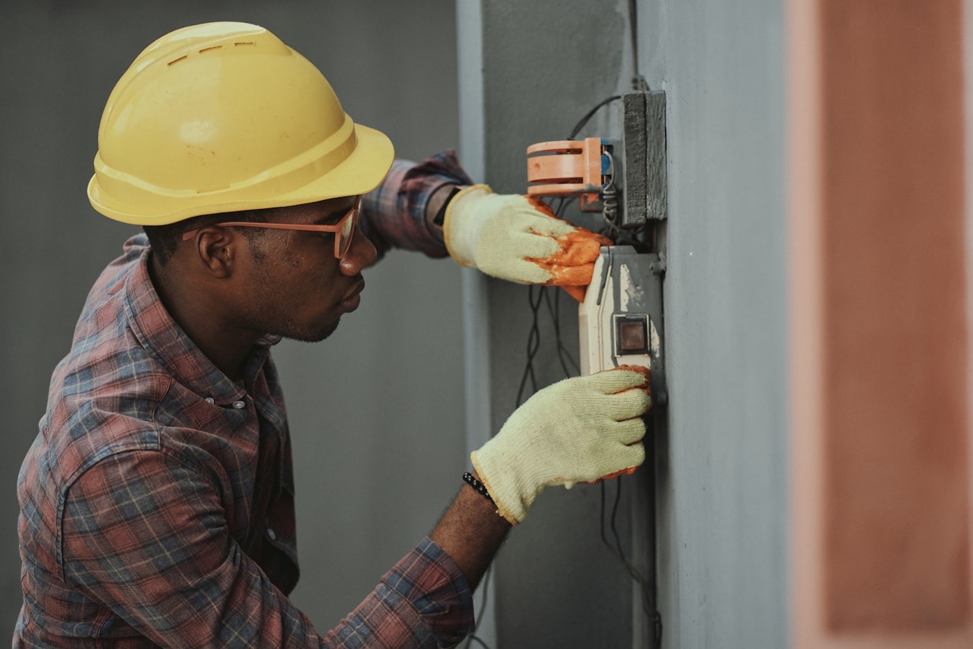 Artisan électricien au travail sur un tableau électrique